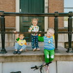 Child wearing the Miffy on the Move bamboo lounge set with bicycle sweatshirt and green joggers