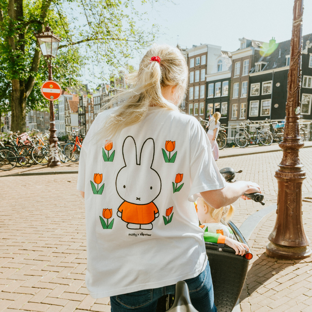 Woman wearing the Miffy white breastfeeding T-shirt with embroidered tulip and nursing zips