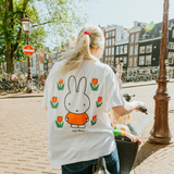 Woman wearing the Miffy white breastfeeding T-shirt with embroidered tulip and nursing zips